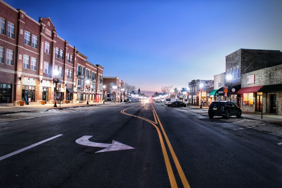 Downtown Algona, Iowa street at dusk with local shops and restaurants