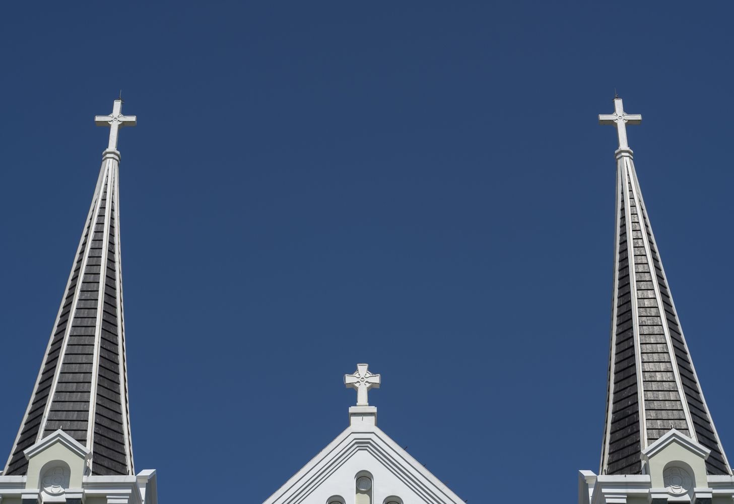 Traditional church steeples against a clear sky