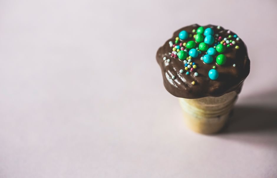 Chocolate dipped soft serve ice cream cone with sprinkles