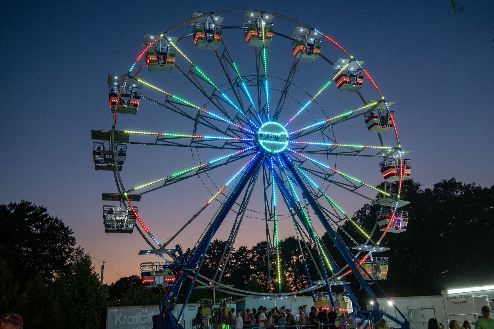 Ferris wheel lit up at a county fair at night