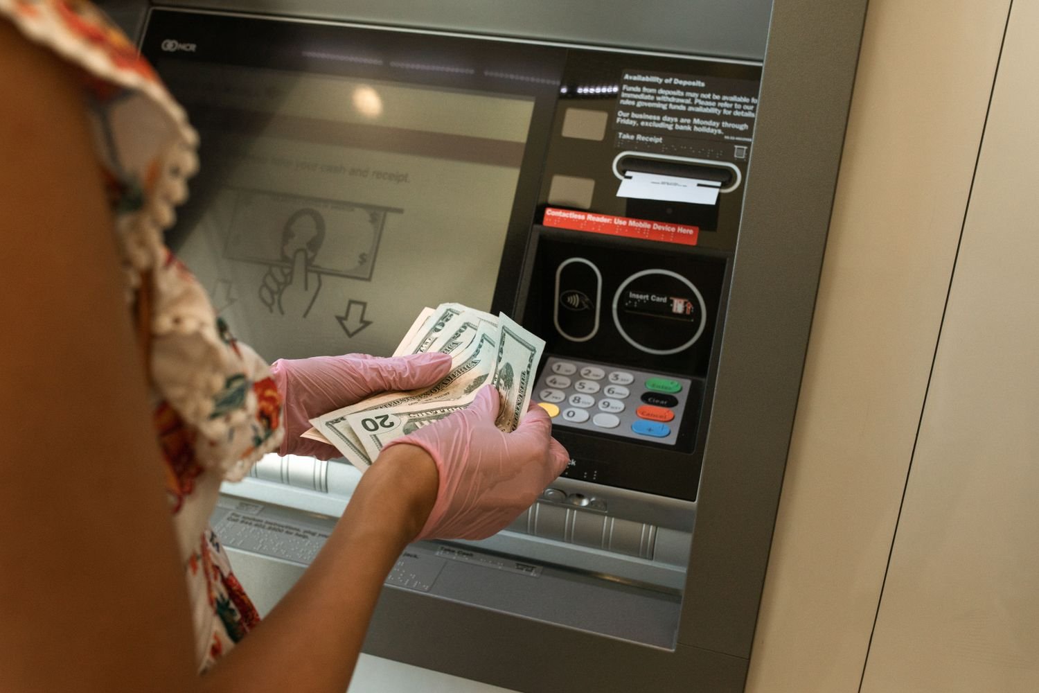 Person withdrawing cash from an ATM