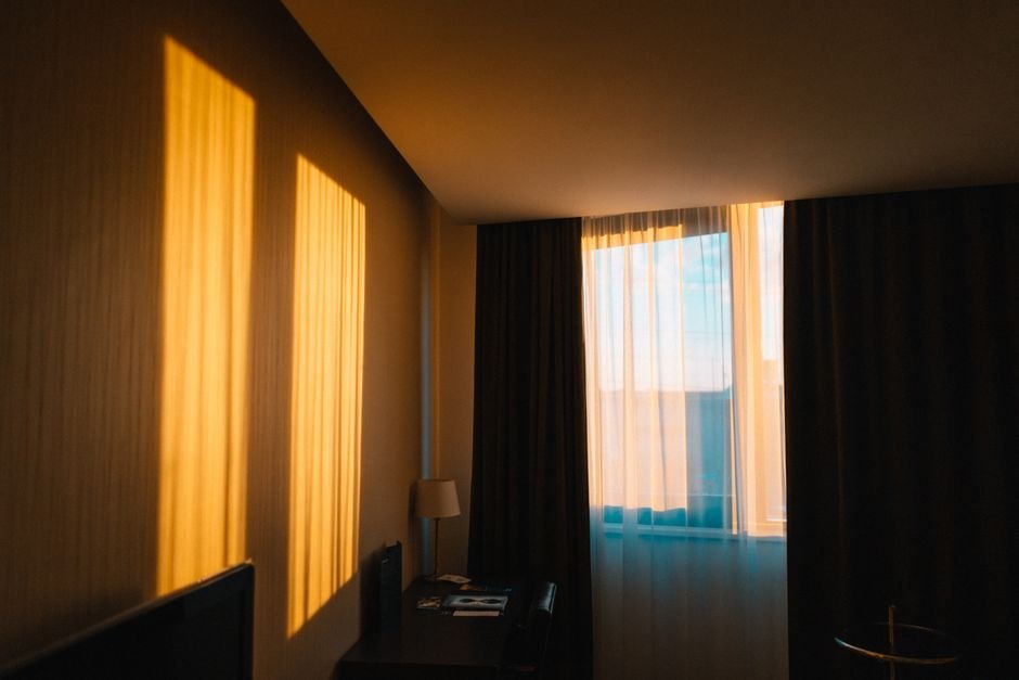 Hotel room interior with warm evening light, similar to Algona Iowa hotel rooms
