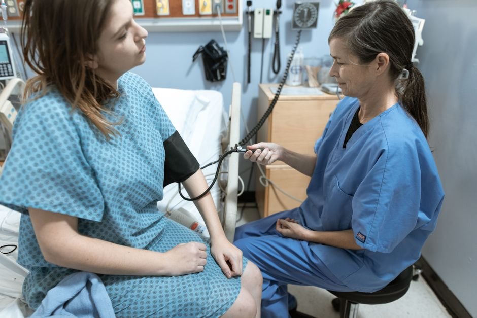 Nurse checking a patient blood pressure during a clinic visit