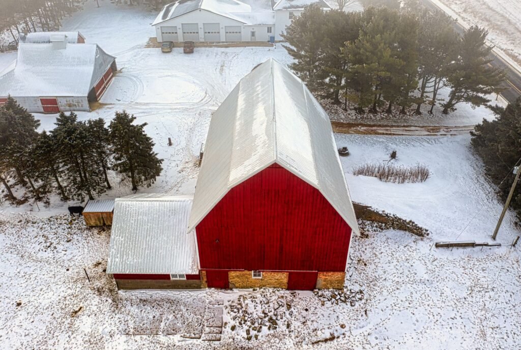 Red barn covered in snow on a Midwest farm in winter