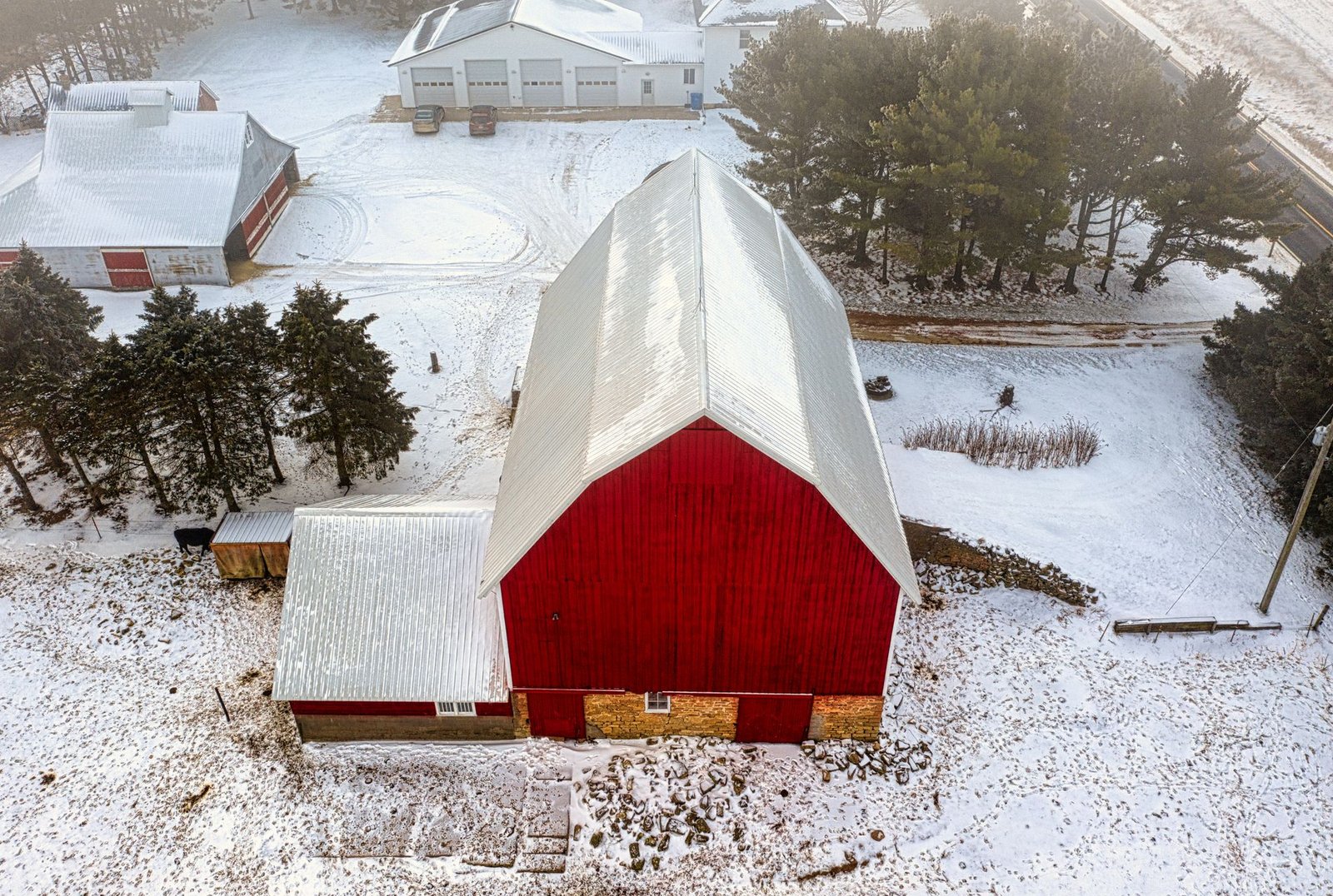 Red barn covered in snow on a Midwest farm in winter
