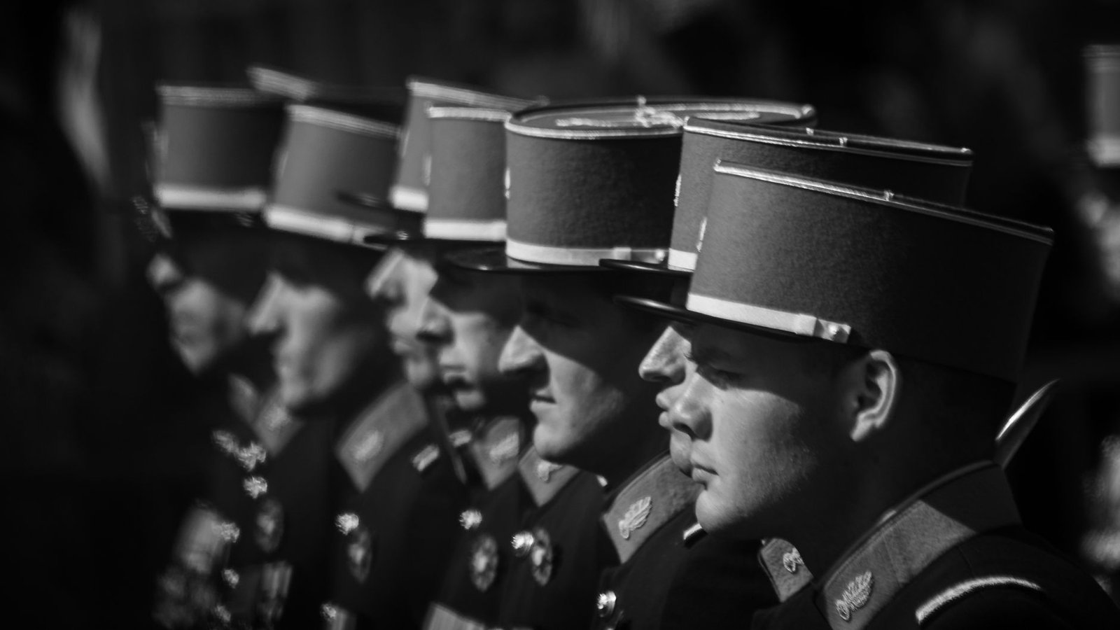 Black and white photo of soldiers in uniform during a formal ceremony, evoking World War II era history